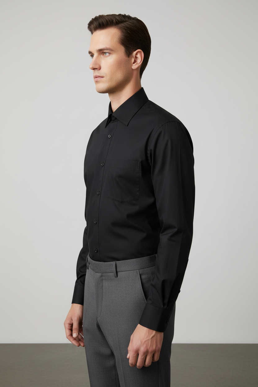 Adult male model wearing the Black long sleeve dress shirt in side profile